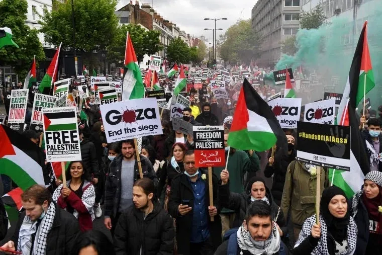 Pro-Palestine protest, London. Professionally developed signs, logos, and slogans in wide circulation. Source: NBC News.
